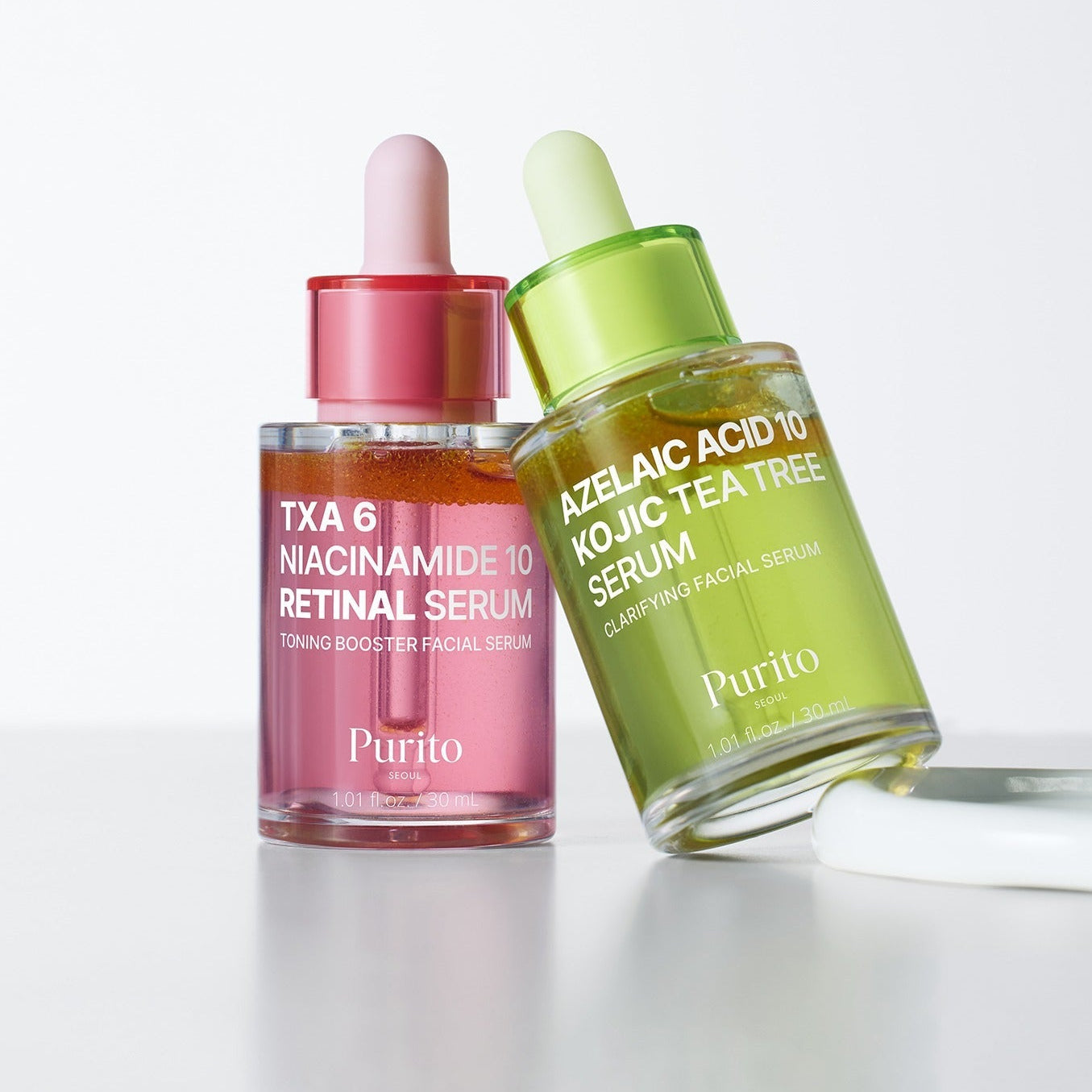 PURITO Tranexamic Acid 6 Niacinamide 10 Retinal Serum 30ml and Azelaic Acid Kojic Tea Tree Serum bottles on display