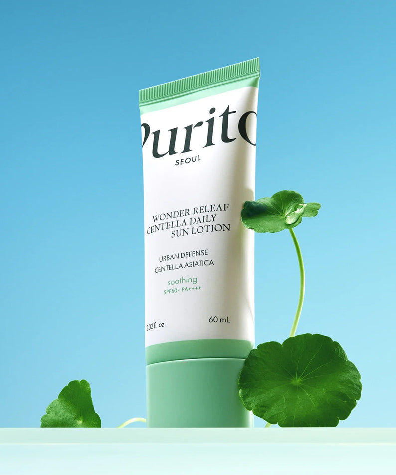 Image of PURITO Wonder Relief Centella Daily Sun Lotion SPF50+PA++++ with Centella Asiatica leaves on a blue background.