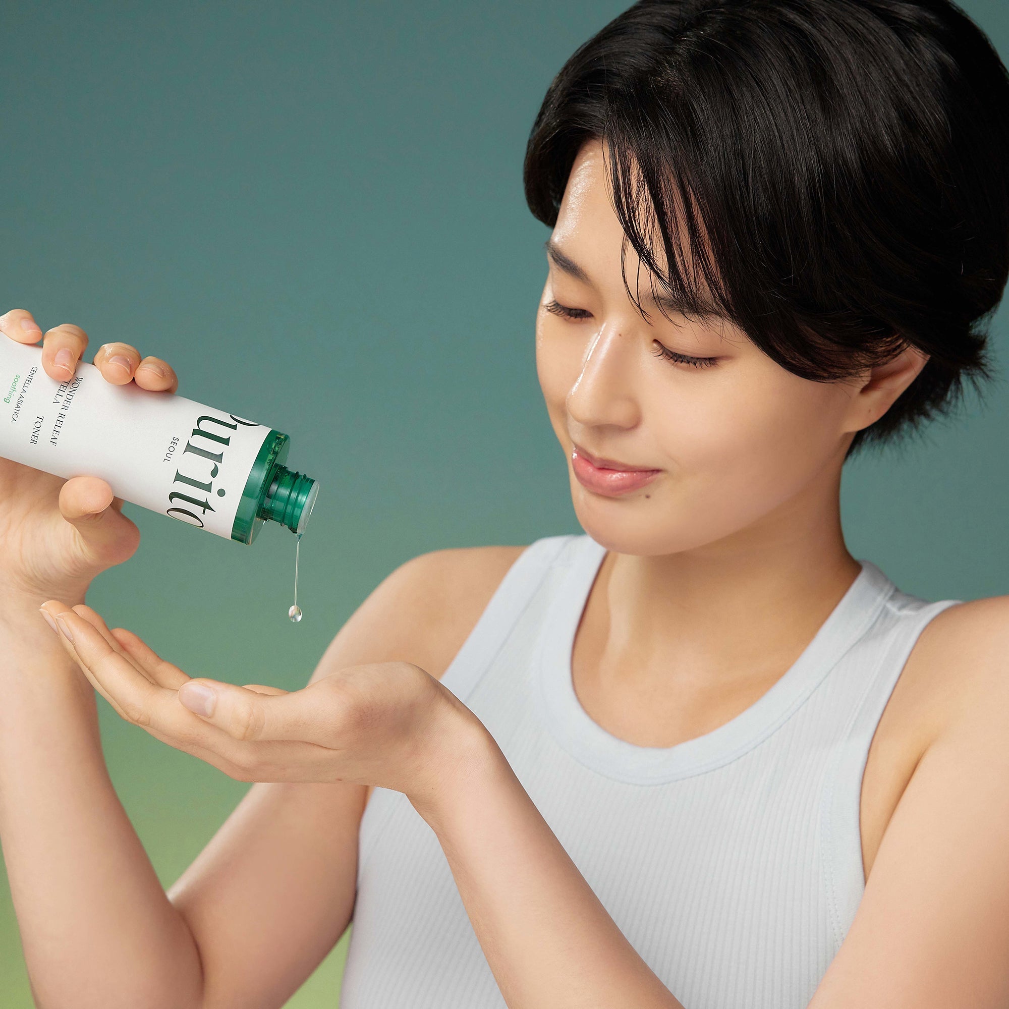Person using PURITO Wonder Relief Centella Toner 200ml for skincare routine