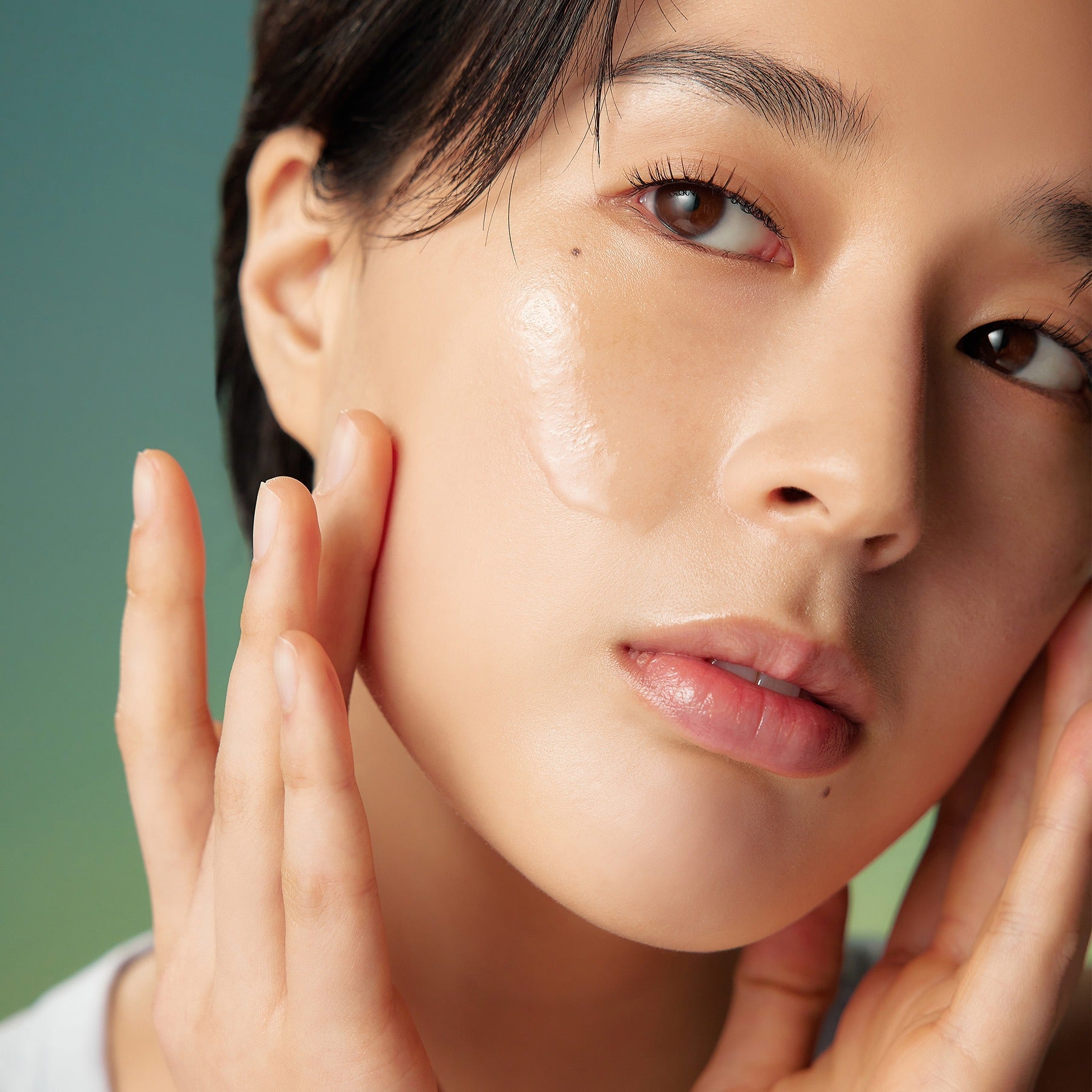 Close-up of a person applying PURITO Wonder Relief Centella Toner 200ml to their face
