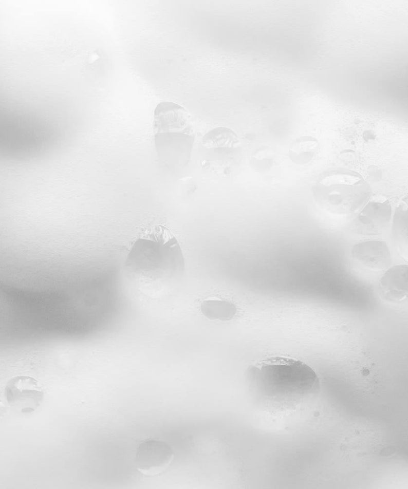 Close-up of foamy lather from PYUNKANG YUL Ato Mildly Acidic Moisturizing Body Wash 590ml showing moisturizing properties.