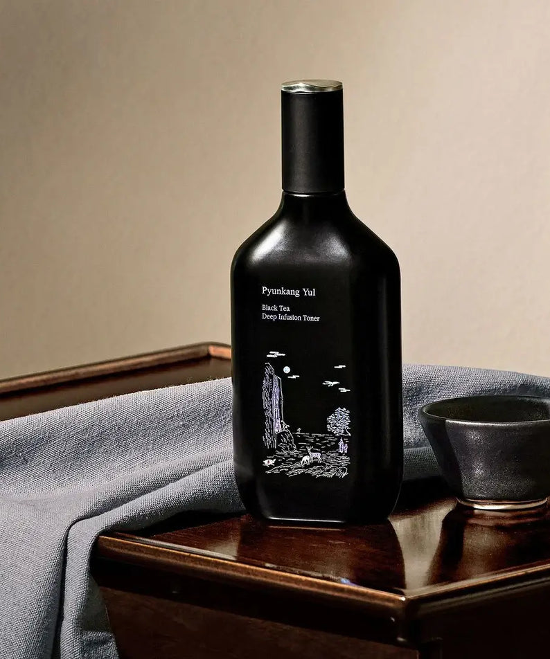 PYUNKANG YUL Black Tea Deep Infushion Toner 130ml bottle on table with cup