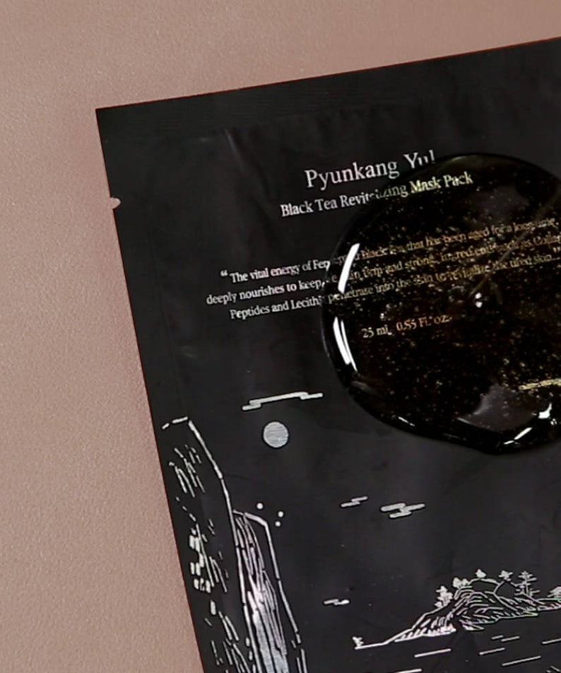 PYUNKANG YUL Black Tea Revitalizing Mask Pack 10 Pieces package on a soft pink surface