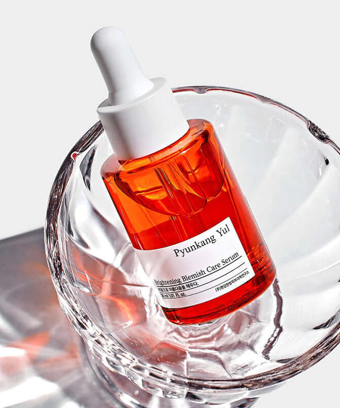 PYUNKANG YUL Brightening Blemish Care Serum 30ml in a clear glass dish with white background