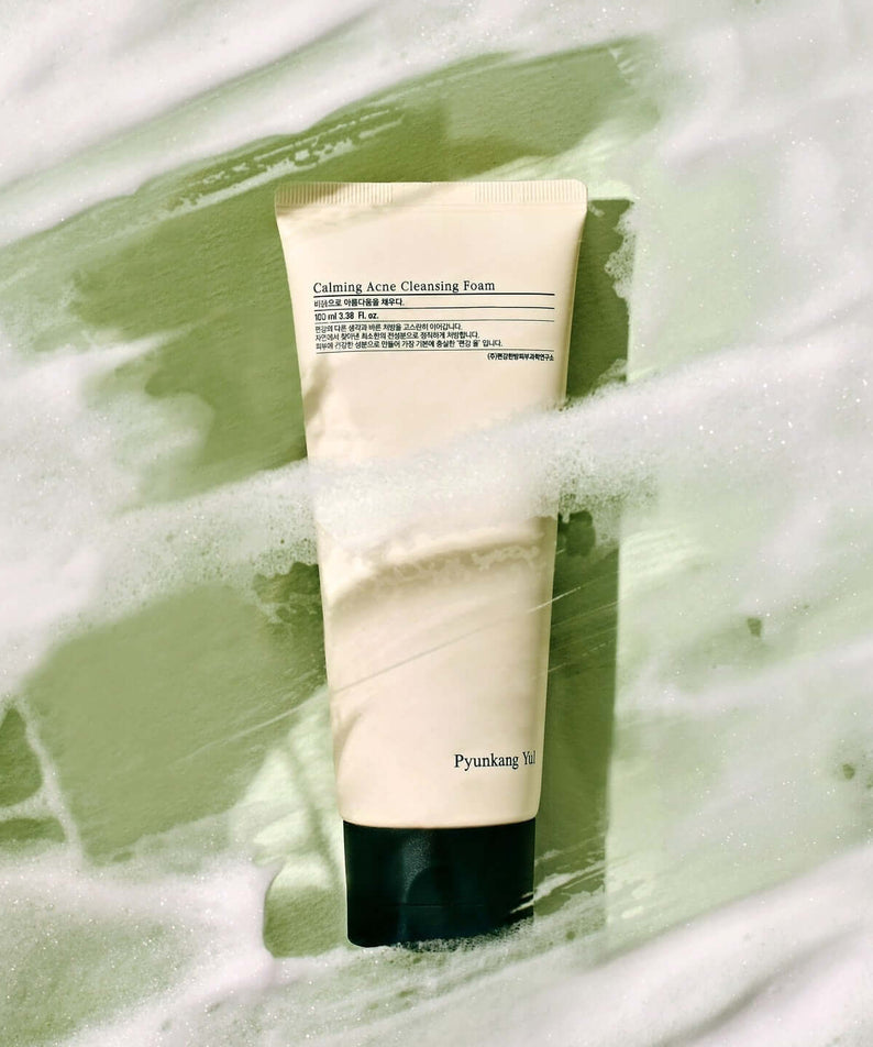 PYUNKANG YUL Calming Acne Cleansing Foam 100ml against a foamy green backdrop