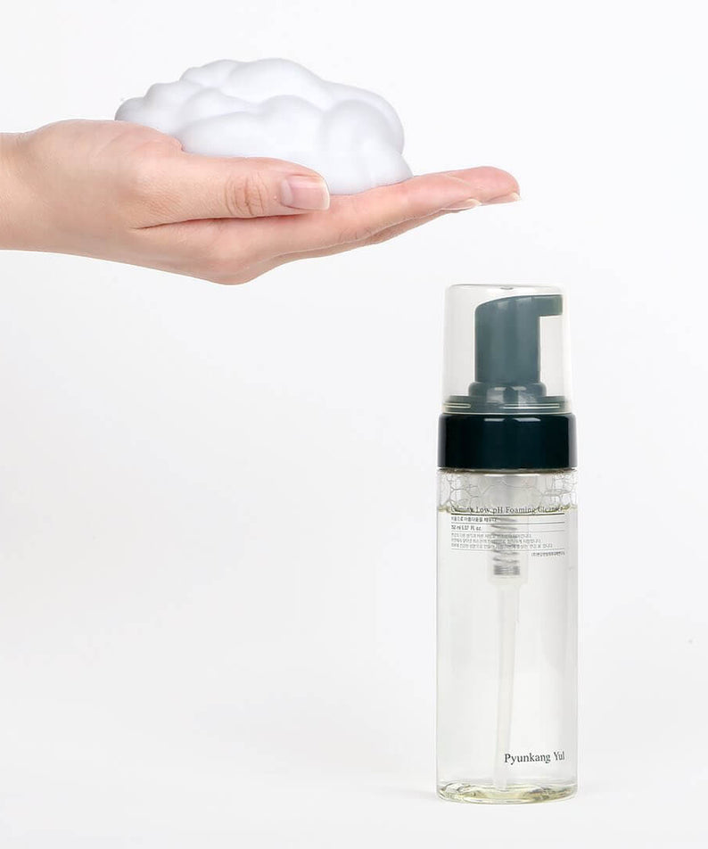 Hand with foam and PYUNKANG YUL Calming Low pH Foaming Cleanser 150ml bottle