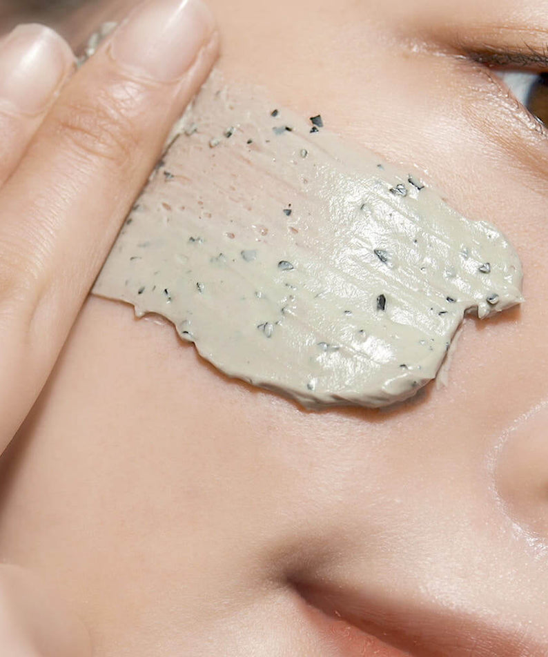 Close-up of PYUNKANG YUL Calming Pore Clear Wash Off Pack 100ml being applied on skin.