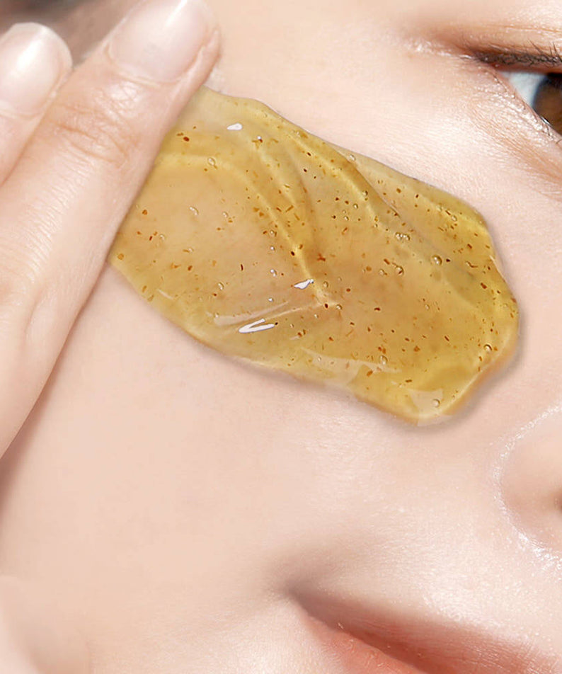 Person applying PYUNKANG YUL Calming Relief Gel Wash-Off Pack 100g to skin, showcasing texture and application.
