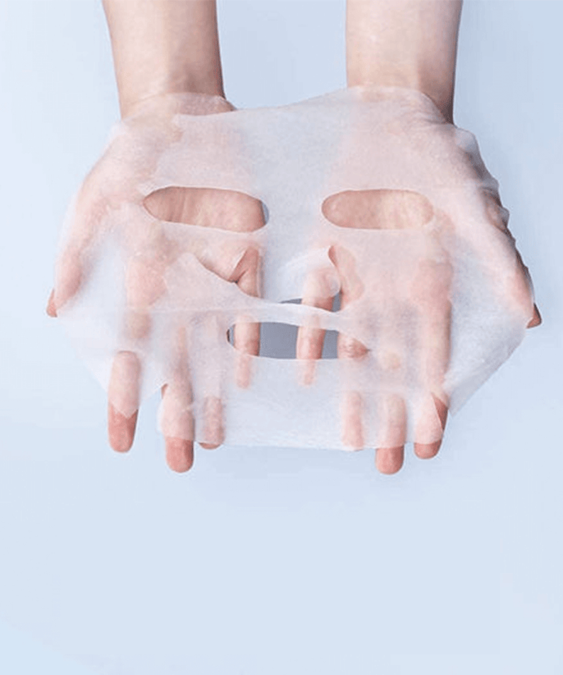Hands holding a sheet from PYUNKANG YUL High Moisture Essence Mask Pack 10 pieces