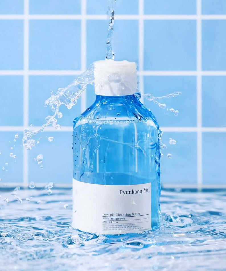 PYUNKANG YUL Mildly Acidic Cleansing Water 290ml bottle with water splash, blue tiled background