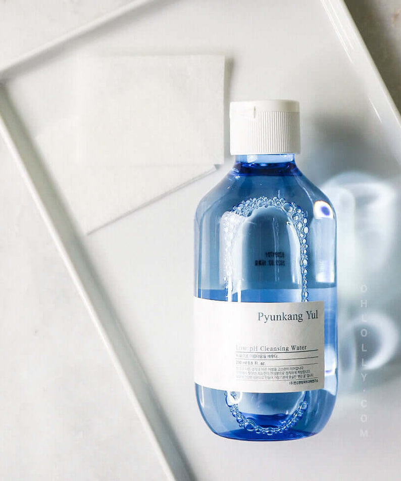 PYUNKANG YUL Mildly Acidic Cleansing Water 290ml bottle on a white tray with cotton pad