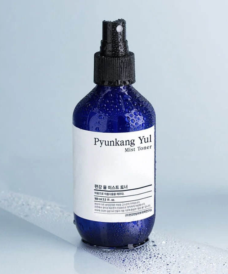 PYUNKANG YUL Mist Toner 200ml bottle with water droplets on a smooth surface.