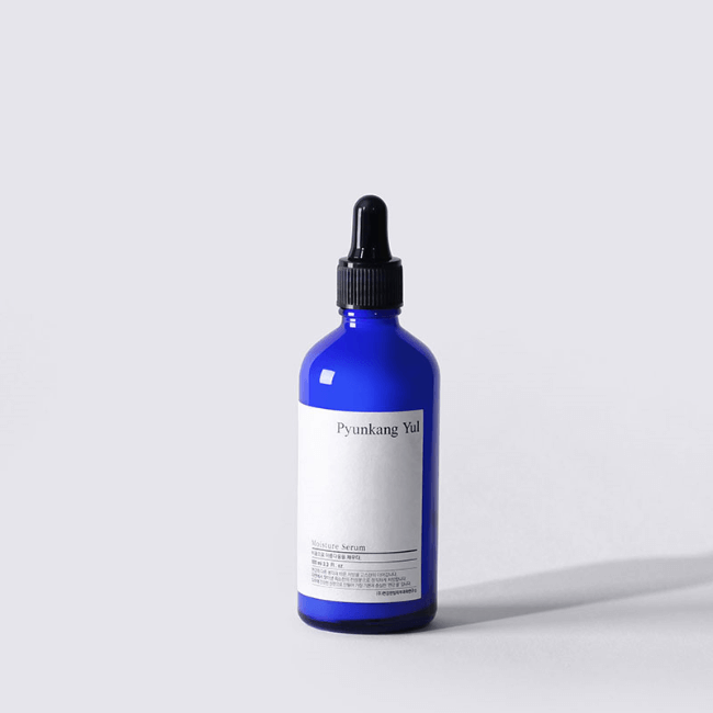 Blue bottle of PYUNKANG YUL Moisture Serum 100ml on a plain background