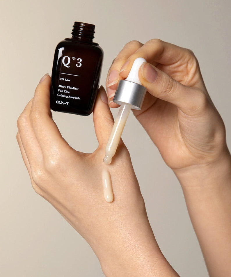 Applying QUA-T Dia Nano Emulsion Full Cica Soothing Ampoule 30ml to skin with dropper.