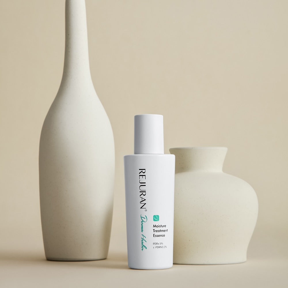 REJURAN Derma Healer Moisture Treatment Essence 70g bottle with decorative vases in a minimalist setting