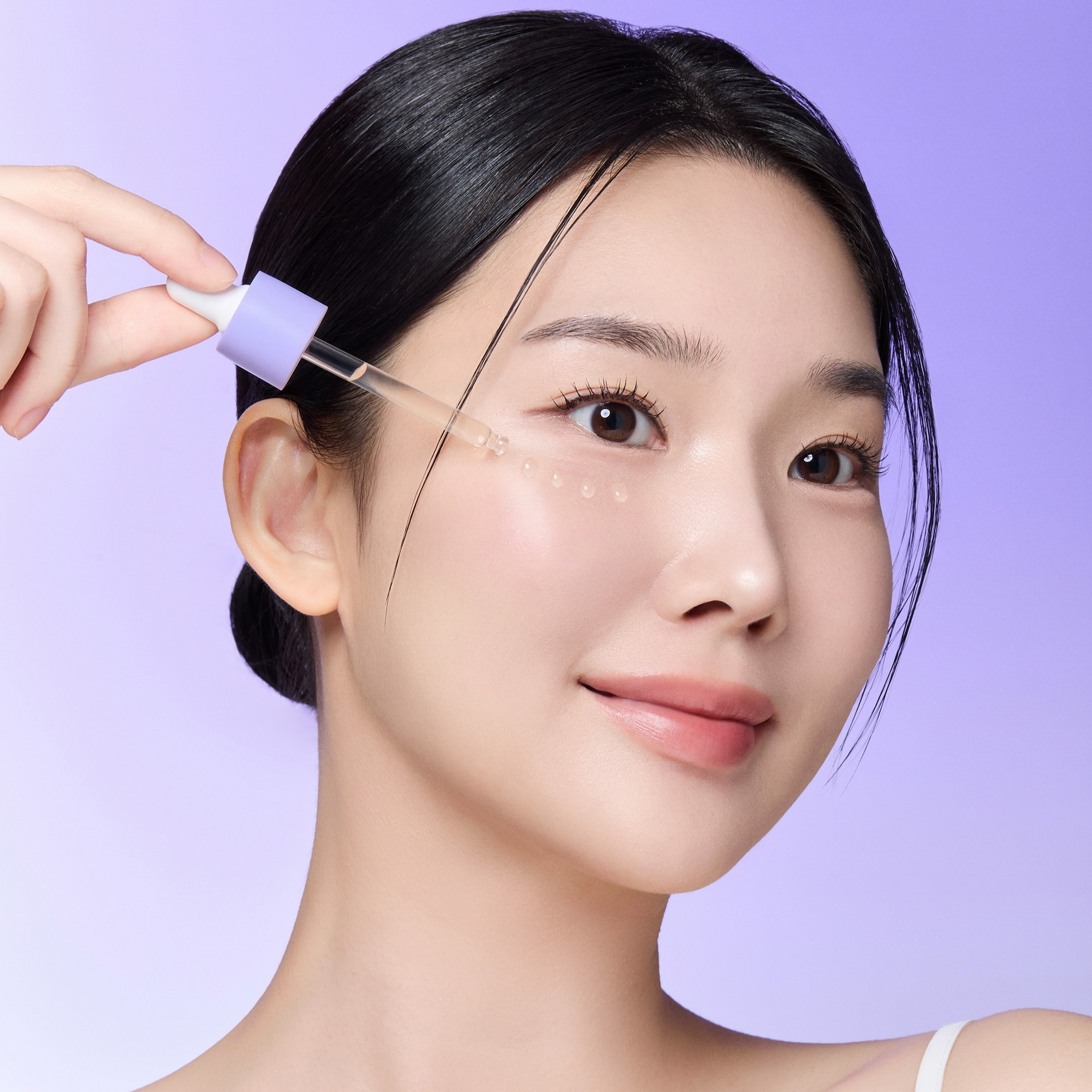 Woman applying REJURAN Derma Healer Pore Tightening Ampoule 30ml on skin with dropper