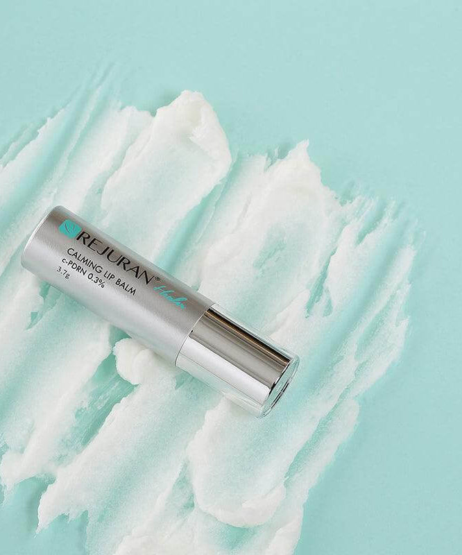 REJURAN Healer Calming Lip Balm 3.7g on textured background
