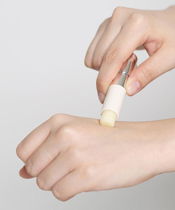 Applying REJURAN Healer Calming Lip Balm 3.7g on hand for skin hydration