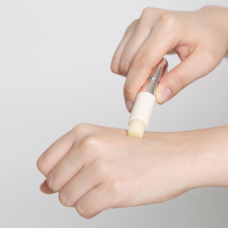 Applying REJURAN Healer Calming Lip Balm 3.7g on hand for skin hydration