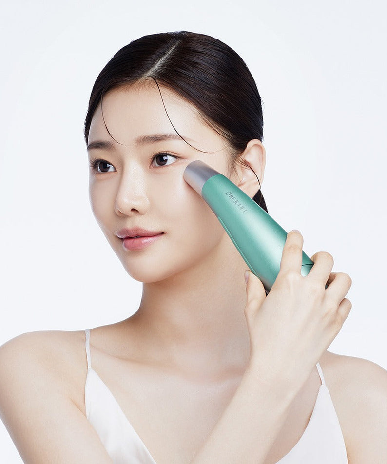 Woman using REJURAN Premium Beauty Device on face for skincare routine.