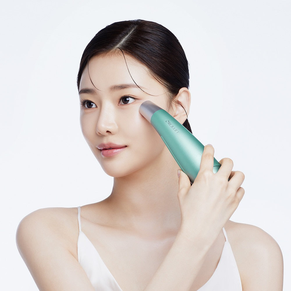 Woman using REJURAN Premium Beauty Device on face for skincare routine.