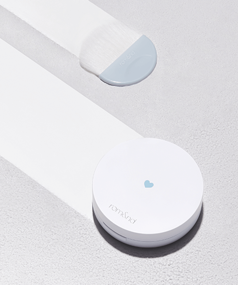 ROMAND Better Than Finish compact and brush on a textured surface