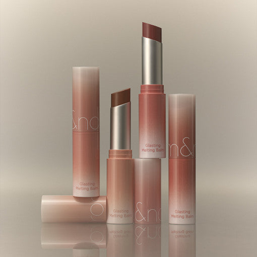 ROMAND Glasting Melting Balm (#01 to #15) lip products displayed elegantly with shades visible in sleek packaging.