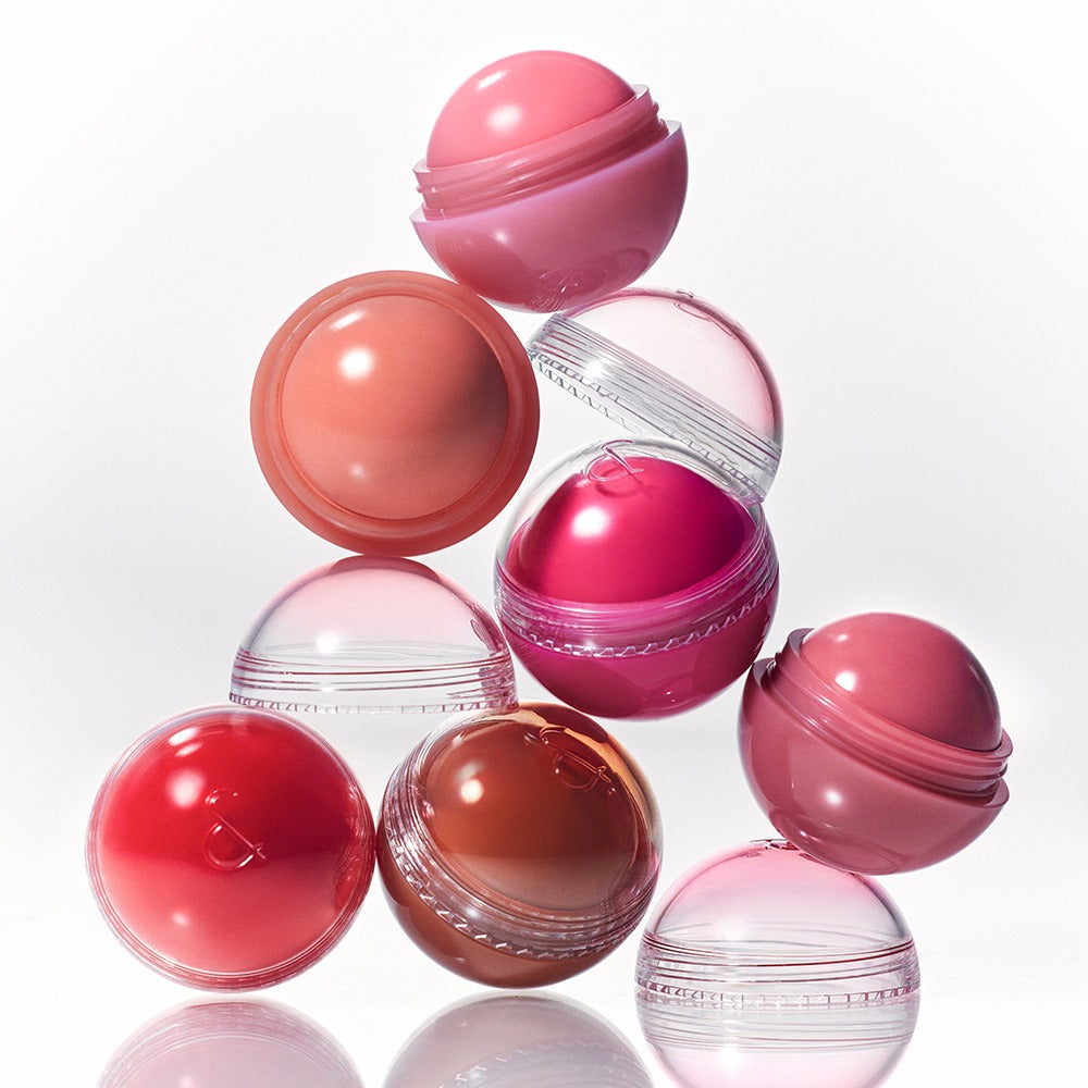 Colorful ROMAND Juicy roll cheek compacts stacked in a creative arrangement.