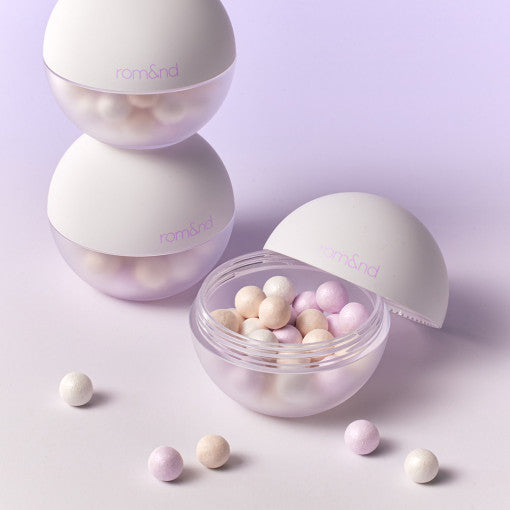 ROMAND Sheer Powder Pearls Powder displaying pastel-colored beads in an open container.