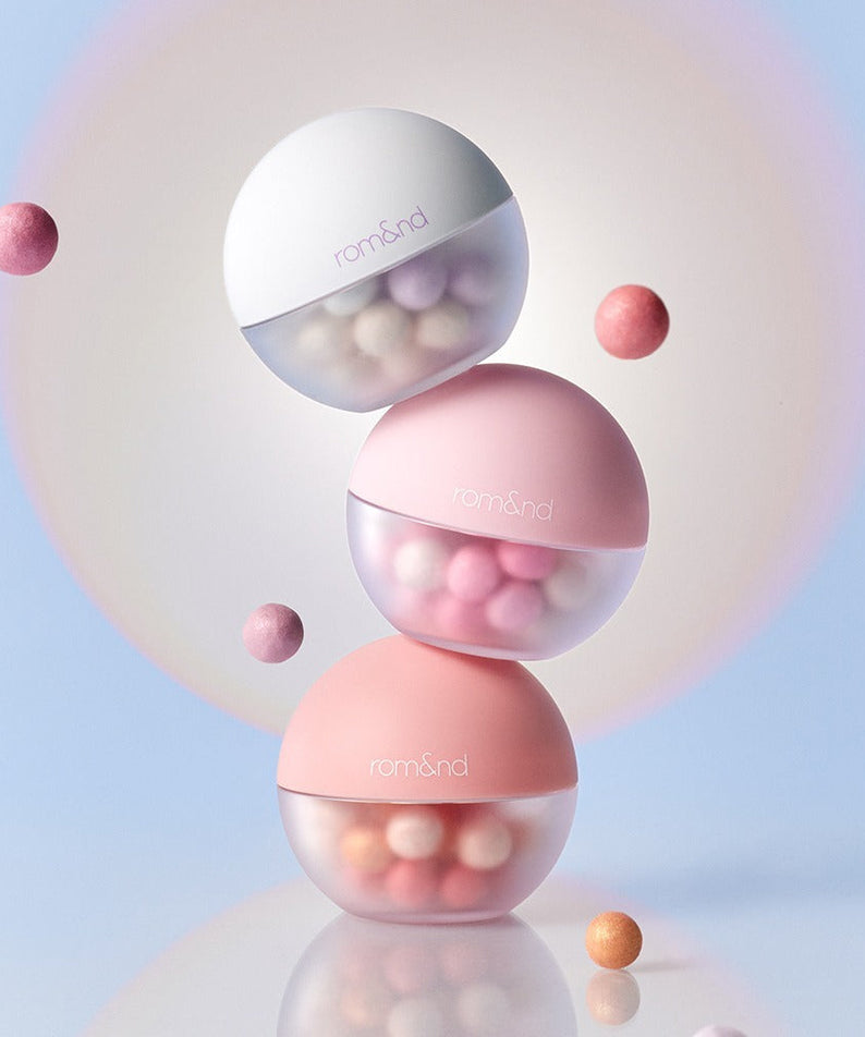 ROMAND Sheer bead powder #KodakMADE in elegant pastel containers with floating beads, creating a light and airy aesthetic.