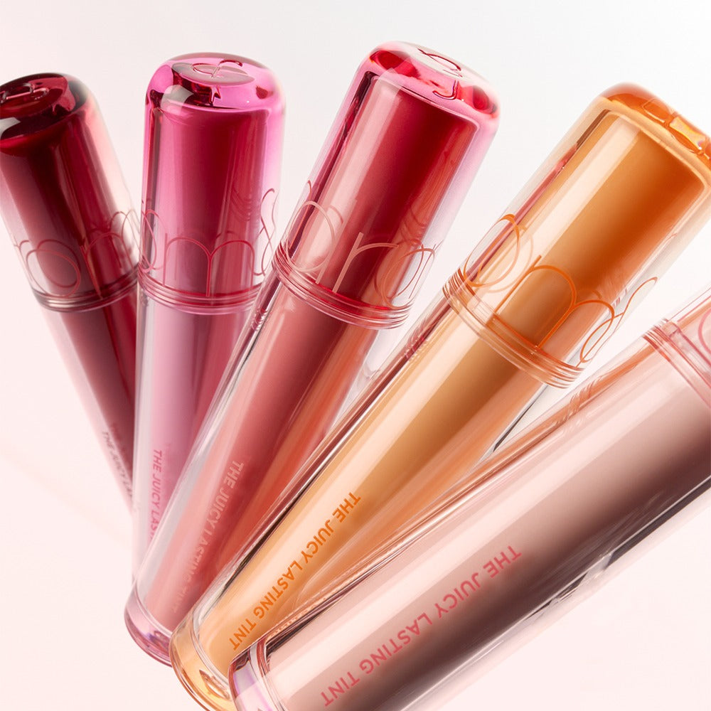 Assorted shades of ROMAND The Juicy Lasting Tint lip products displayed elegantly.