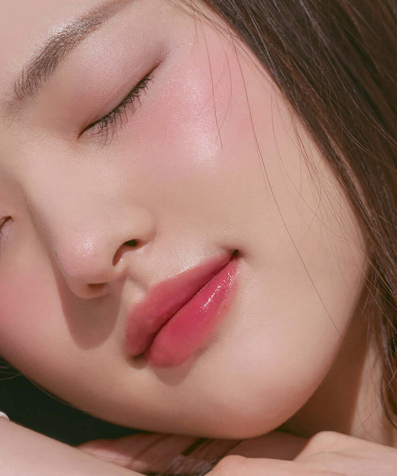 Close-up of a woman wearing ROMAND better than cheek #springfever blush, showing soft, natural makeup look with rosy cheeks.