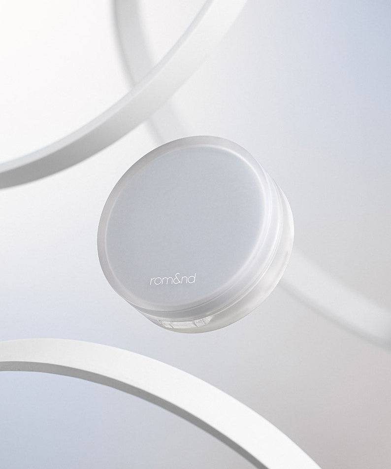 ROMAND nu zero cushion, a minimalist skincare product with sleek packaging, displayed against a modern white backdrop.