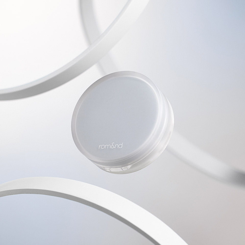 ROMAND nu zero cushion, a minimalist skincare product with sleek packaging, displayed against a modern white backdrop.
