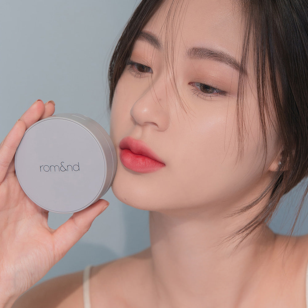 Model showcasing ROMAND zero cushion compact.