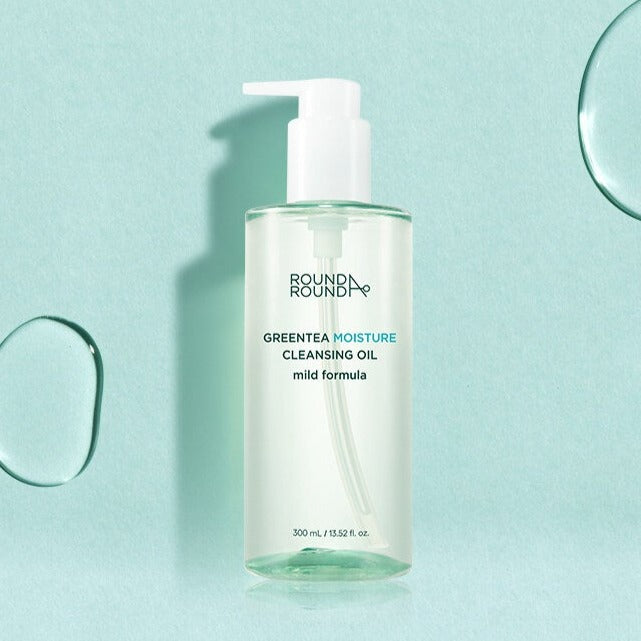 Bottle of ROUND A'ROUND Greentea Moisture Cleansing Oil 300ml with pump on mint green background