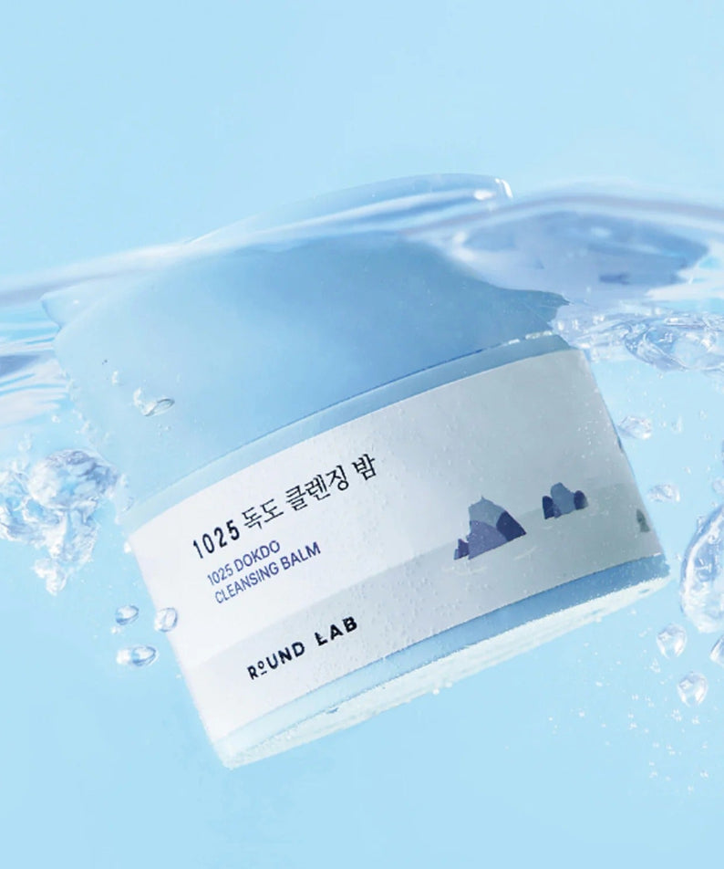 ROUND LAB 1025 Dokdo Cleansing Balm 50ml submerged in water, showcasing product design and label