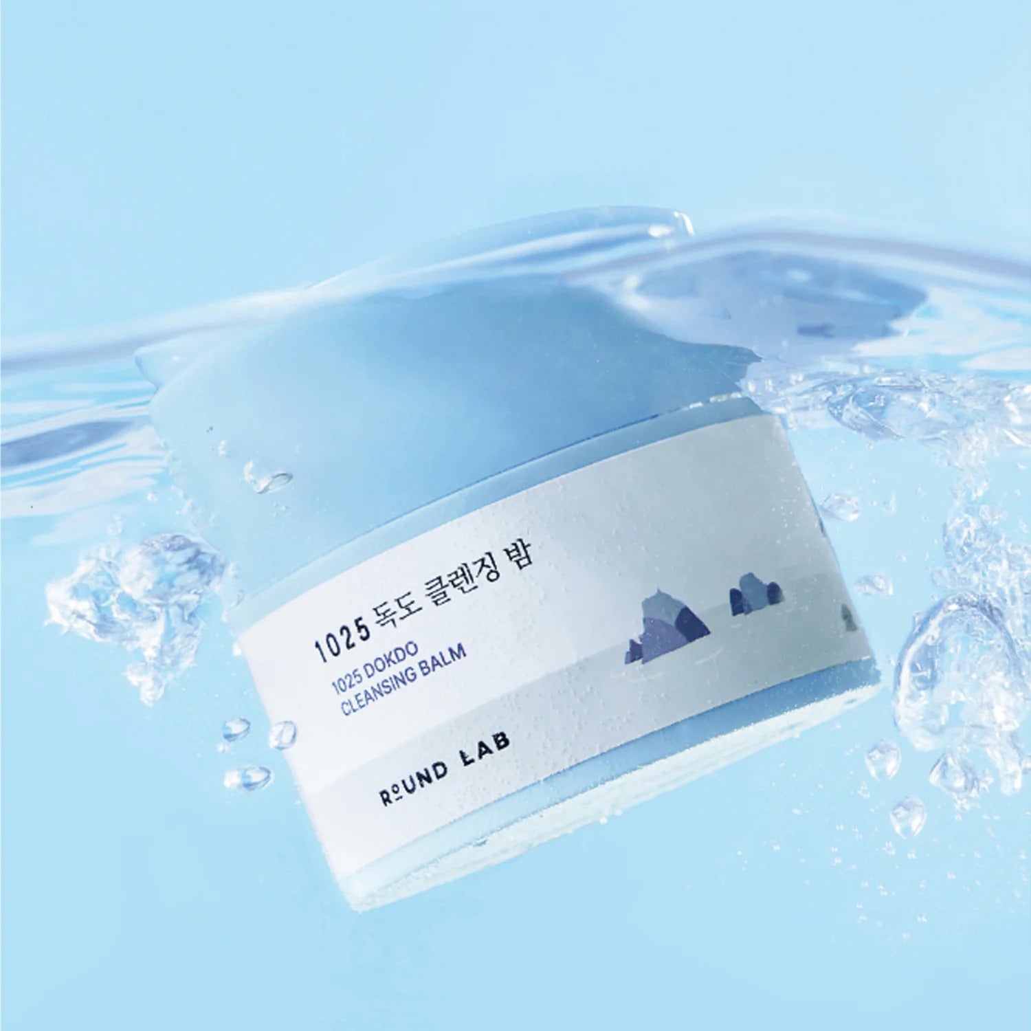ROUND LAB 1025 Dokdo Cleansing Balm 50ml submerged in water, showcasing product design and label