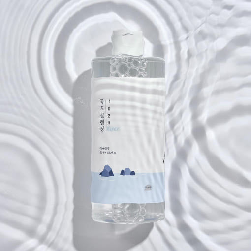 ROUND LAB 1025 Dokdo Cleansing Water 400ml bottle on wavy surface pattern background