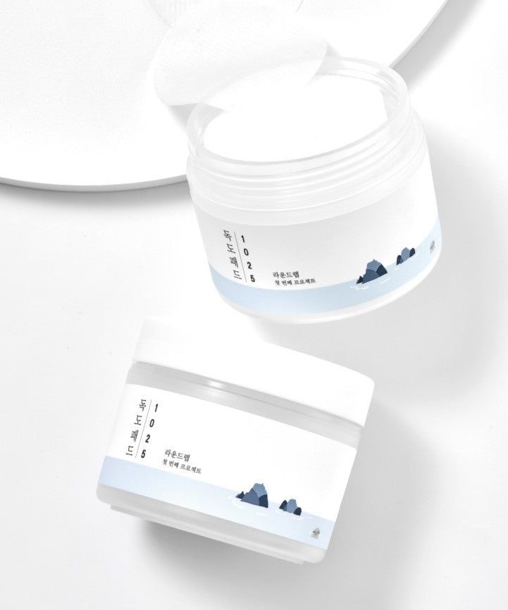 ROUND LAB 1025 Dokdo Pad 70p 120ml in white packaging on a white background, open jar with pads exposed.