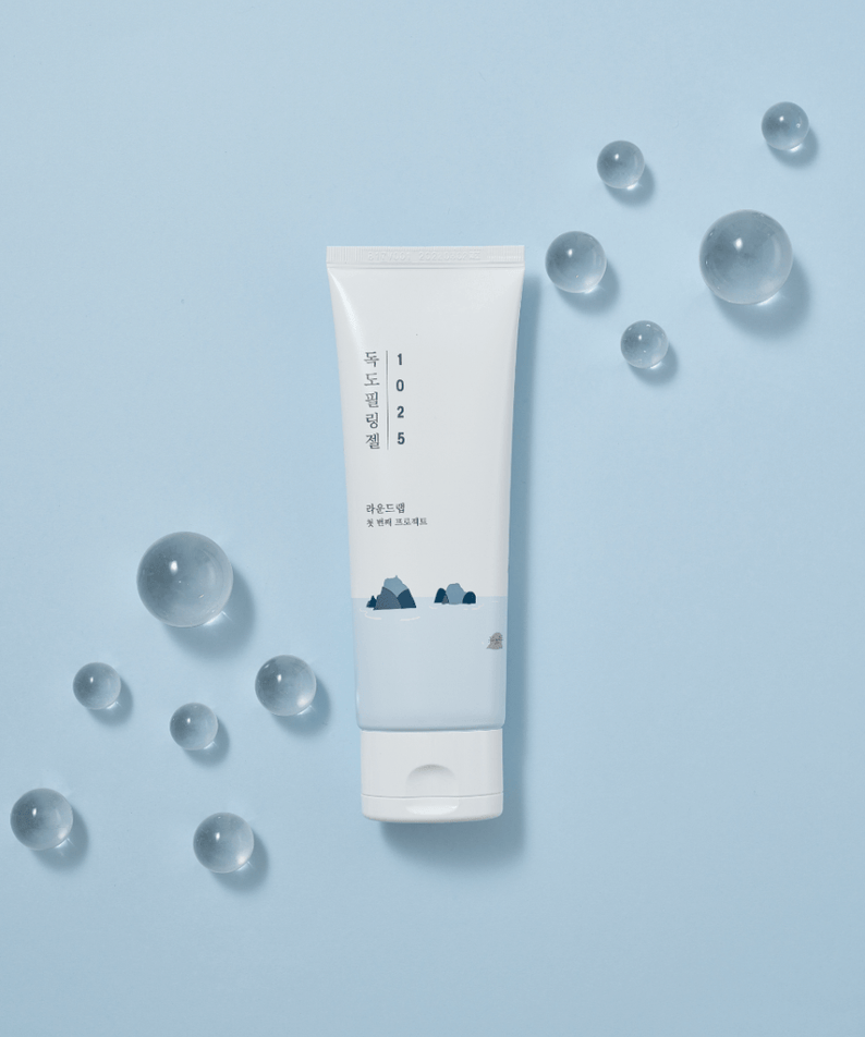 ROUND LAB 1025 Dokdo Peeling Gel 120ml product on blue background with decorative clear spheres.