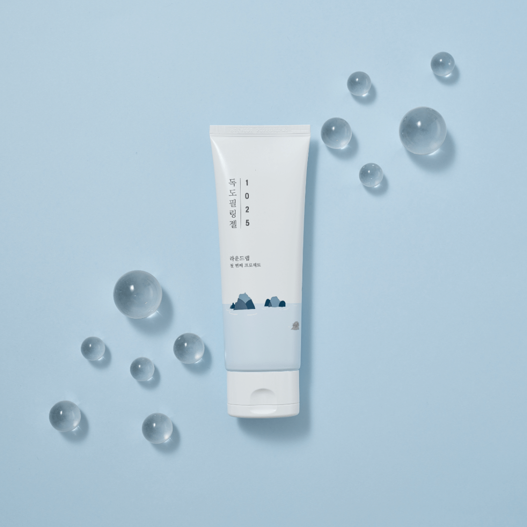 ROUND LAB 1025 Dokdo Peeling Gel 120ml product on blue background with decorative clear spheres.