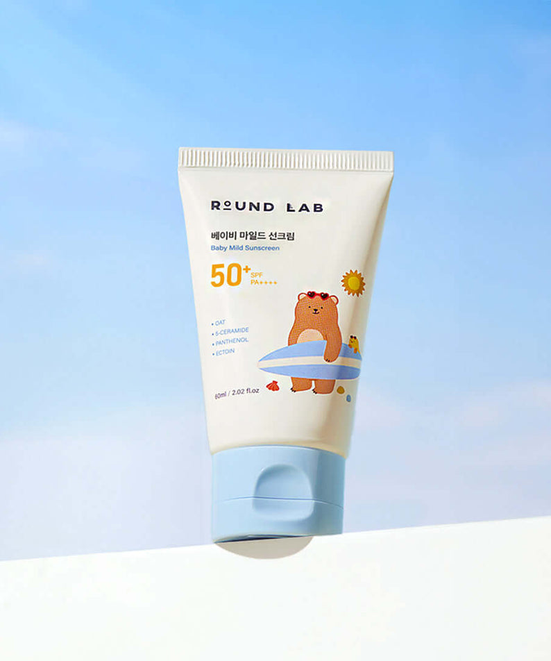 ROUND LAB Baby Mild Sun Cream 60ml with SPF 50 packaging against a blue sky background