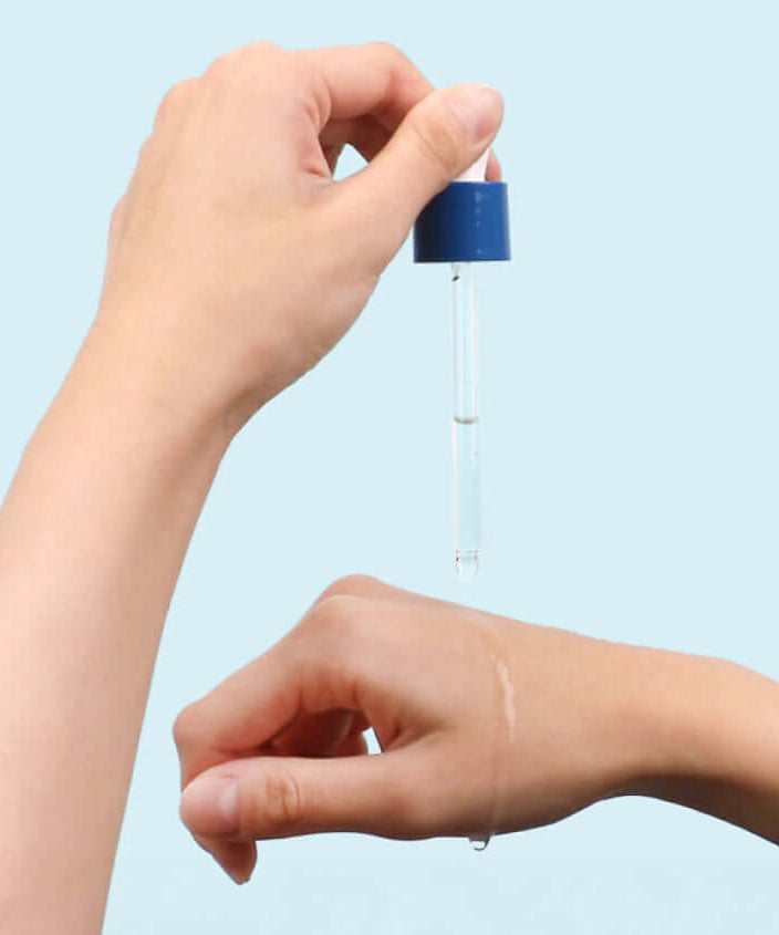 Application of ROUND LAB Birch Moisture Ampoule 50ml on hand with dropper