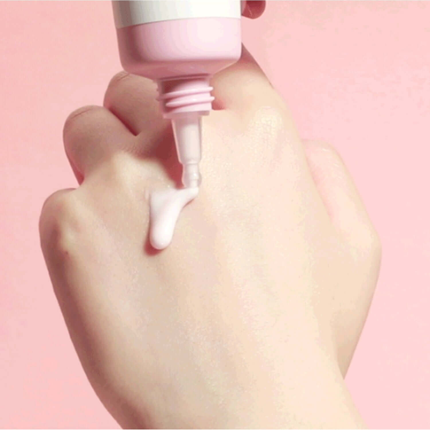 ROUND LAB Dongbaek Deep Collagen Elasticity Sun Serum 50ml being dispensed onto hand for skin care routine.