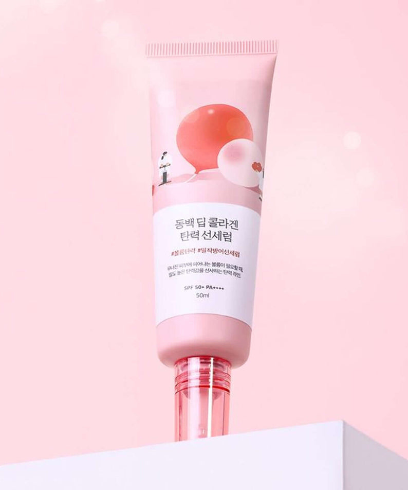 ROUND LAB Dongbaek Deep Collagen Elasticity Sun Serum 50ml, pink design bottle on a soft pink background.