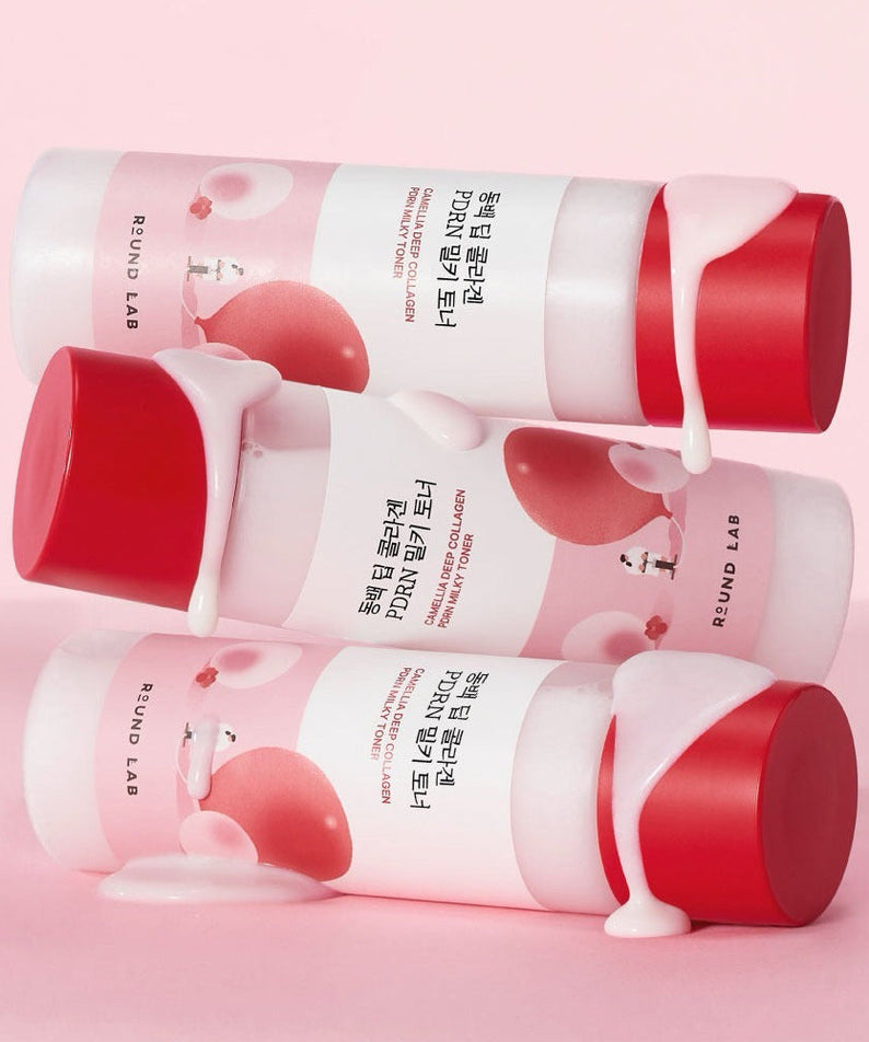 ROUND LAB Dongbaek Deep Collagen PDRN Milky Toner 150ml with red caps and creamy texture on pink background