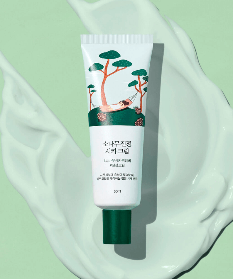 ROUND LAB Pine Calming Cica Cream 50ml tube on a green background with cream swirls