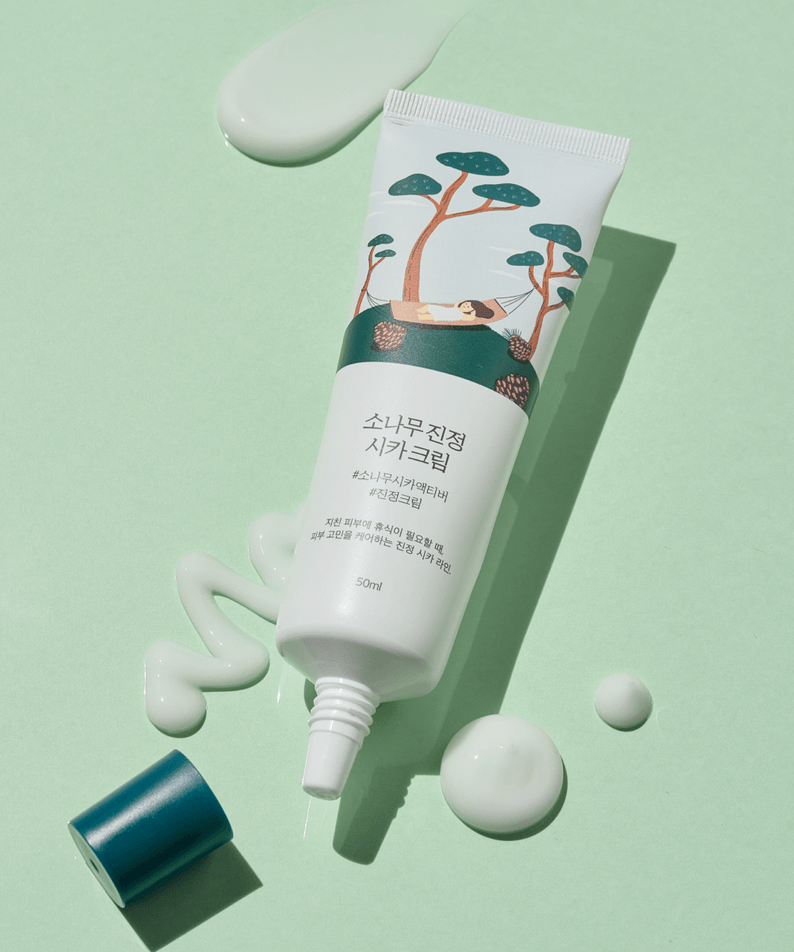 ROUND LAB Pine Calming Cica Cream 50ml tube on green background with cream texture visible