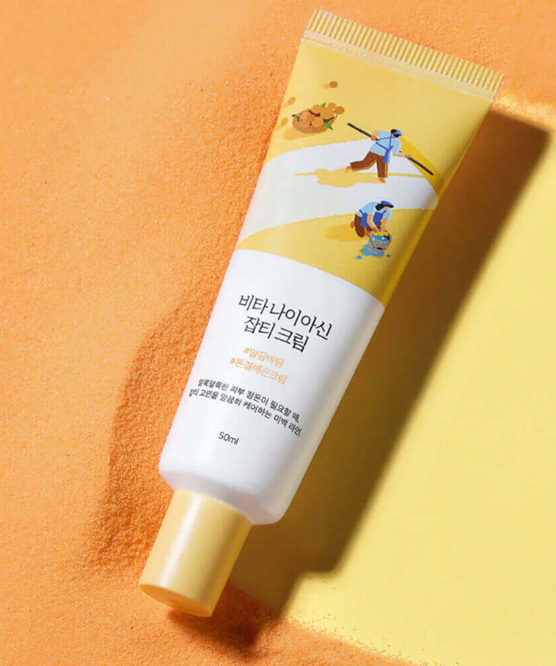 ROUND LAB Vita Niacin Spot Cream 50ml on a sandy background